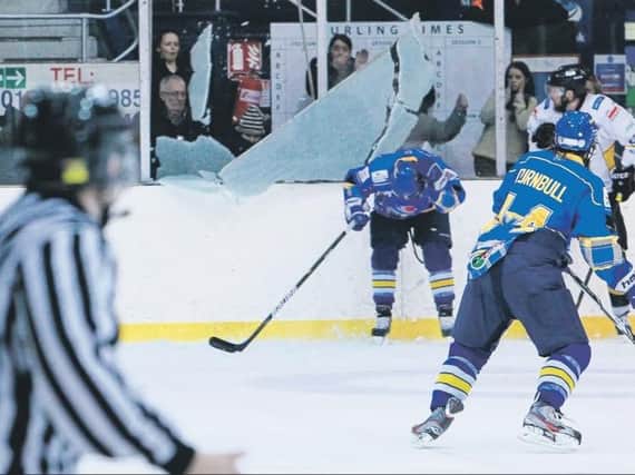 Fife Flyers Kris Hogg is showered in glass as the plexi shatters during the play-off quarter-final with Nottingham Panthers in 2013. Pic: Steve Brown