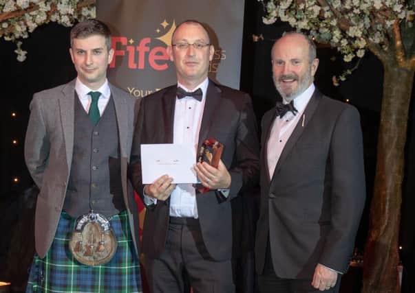 Excellence in Community Engagement category sponsored by Rennies Coaches, presented by David Frenz, Operations Director at Stagecoach East Scotland and host Fred MacAulay to MKM Building Supplies. Pic: Kenny Smith.