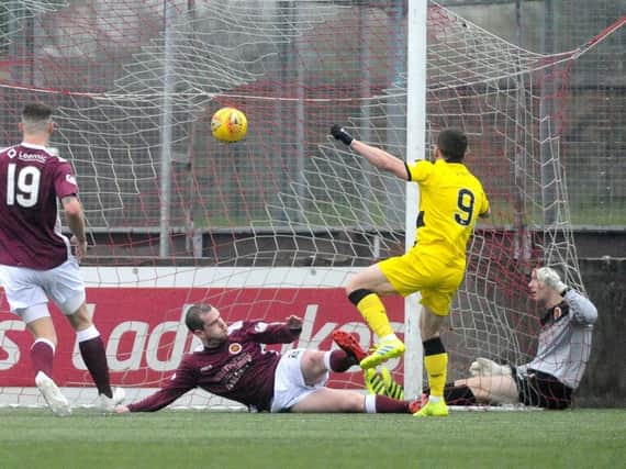 Liam Buchanan smashes home Raith's injury-time equaliser. Pic: Alan Murray