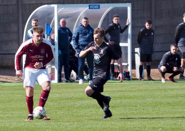 The United bench watch on as Linlithgow go on the attack. Picture by Blair Smith.
