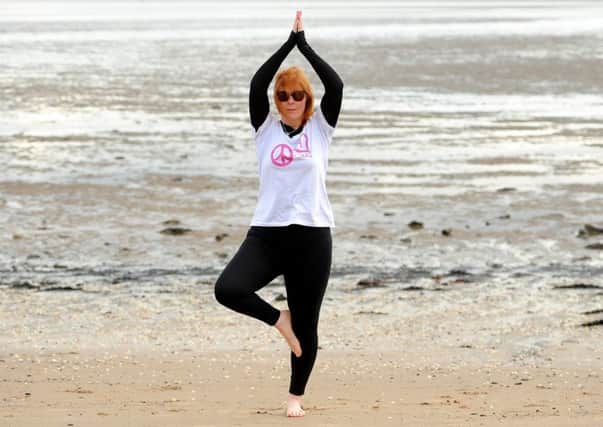 Cara practises yoga on Burntisland beach. Pics by FPA