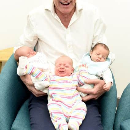 Graham with Fife's newest triplets six week old Hilda, Ylva and Freda Dudley-Vaughan. Pic credit: Fife Photo Agency.