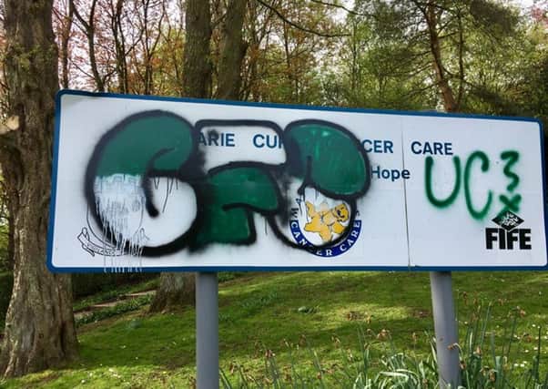 The vandalised sign at the Marie Curie 'Field Of Hope' garden. (Pic David Cooper).