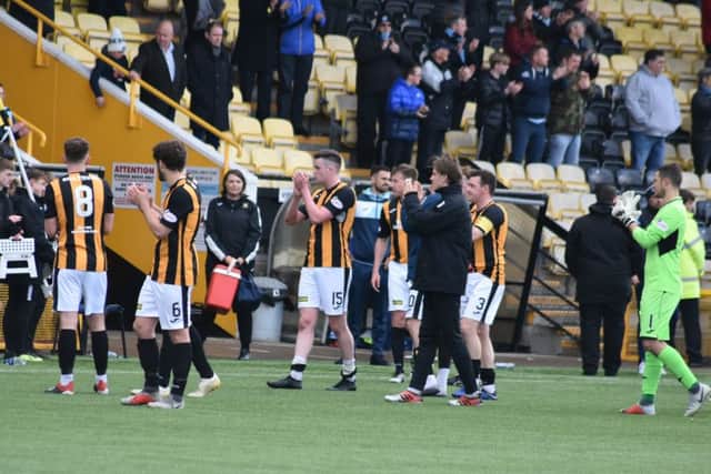 East Fife's players applaud their fans.