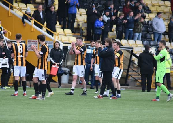 East Fife's players applaud their fans.