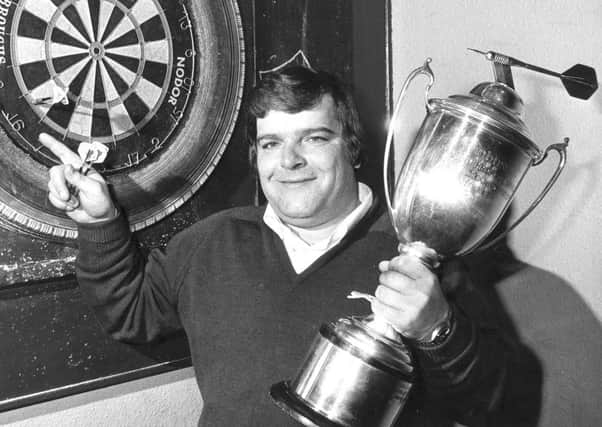 Jocky Wilson in Kirkcaldy with the Embassy Darts World Championship trophy after beating John Lowe in 1982