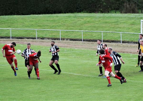 The Newburgh defence defend John Martin's header. Picture by Graham Strachan.