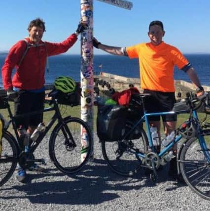 Neil Thain and Jamie Fraser who completed their fundraising cycle on May 17. They are pictured at John O'Groats.