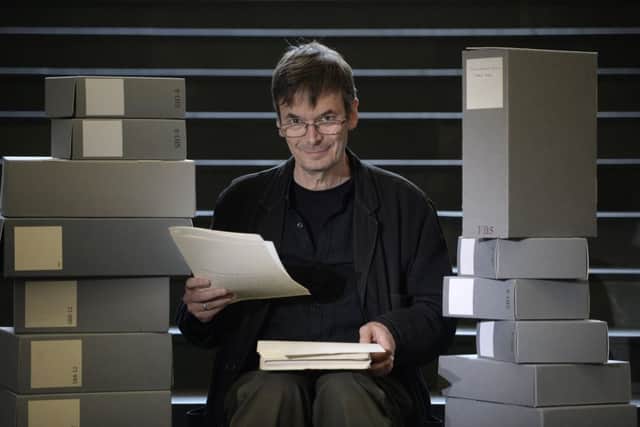 Ian Rankin holding his 1984 manuscript for his first published novel Flood, with some of the 50 boxes of his own personal archive which he is donating to the National Library of Scotland. Pic: SWNS