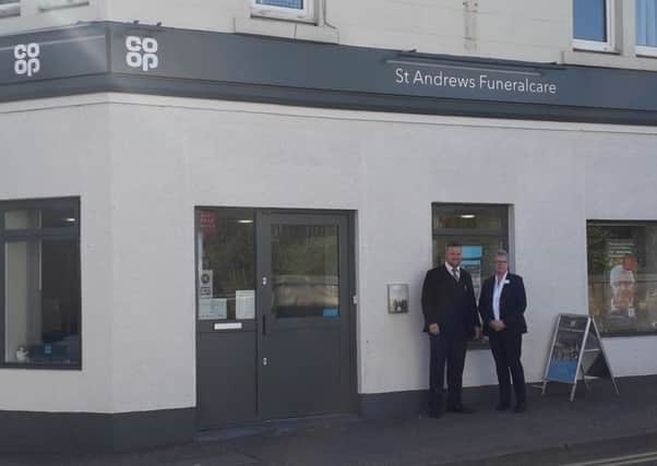 Neil and Pauline outside the St Andrews branch.