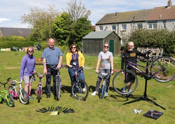 Staff from Fife Housing Group with Shuggy Hughes (right)