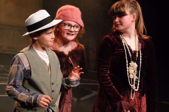 Members of the YMTS performing on stage in Annie Jnr.

Pic: Hannah Wilson.