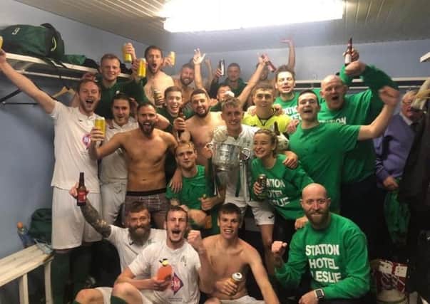 Thonrton Hibs players celebrate in the dressing room after winning the V Tech SMT Cup final with a 3-2 victory over Livingston in Bathgate.