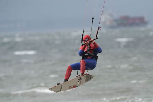 Clinto dressed as Spiderman demonstrating kitesurfing. Pic: George McLuskie.