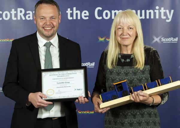 Presenter Angus Thom with Kinghorn artist Lynette Gray as she accepts the award for Outstanding Contribution to Community Rail at the ScotRail in the Community Awards 2019.