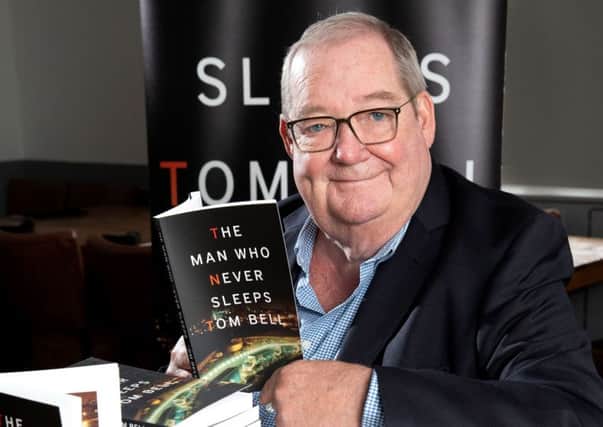 Author Tom Bell with his book The Man Who Never Sleeps.