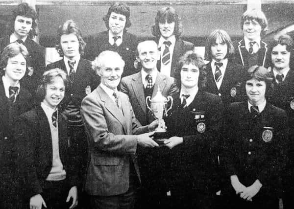 Peter Ross is awarded with Fife School's U18 league trophy