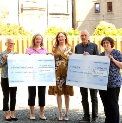 Cat presents cheques to the two Kirkcaldy charities