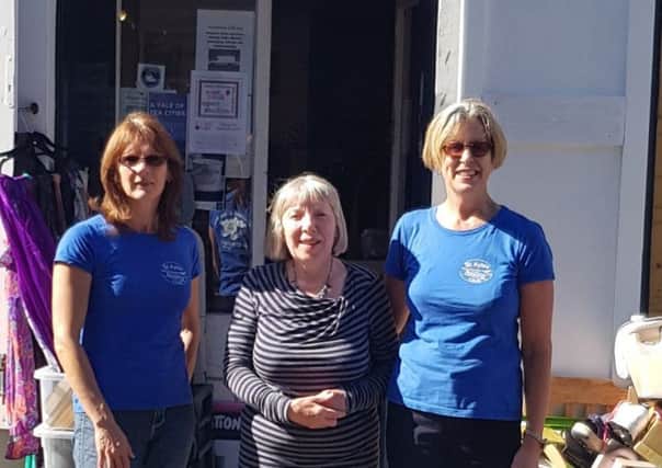 Members of the club pictured with Elizabeth (centre) outside the shop.