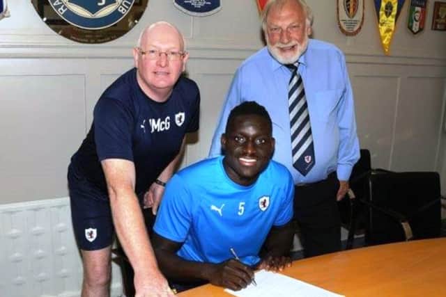 Fernandy Mendy with Raith Rovers manager John McGlynn and chairman Bill Clark. Pic: Tony Fimister