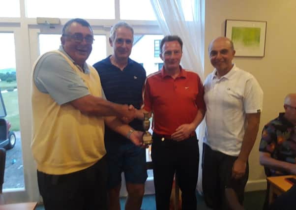 Seen with club captain, Iain Lawson, who presented the Midnight Madness Trophy, is the winning team of Chris Pratt, John Mill and Iqbal Latif.
