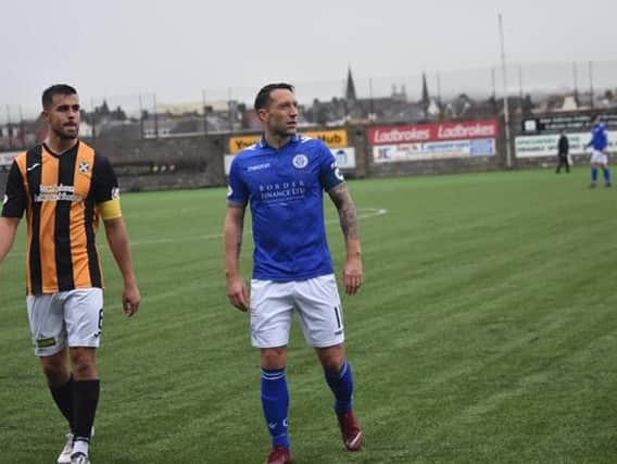 Craig Watson goes toe to toe with Stephen Dobbie during a meeting between the two sides last season.