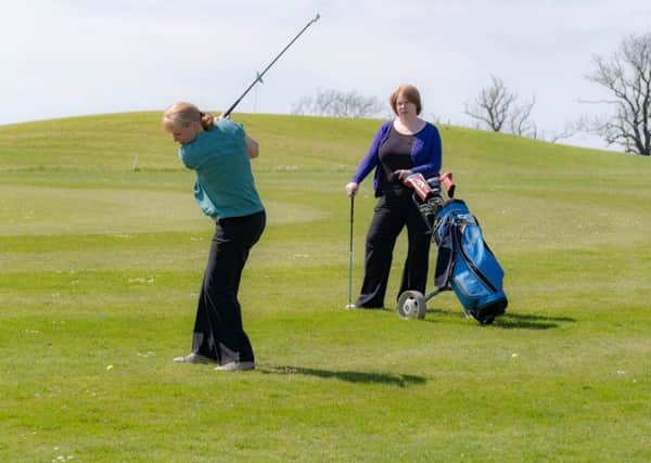 Dr Fiona Skillen, in the purple, enjoys a round of golf.