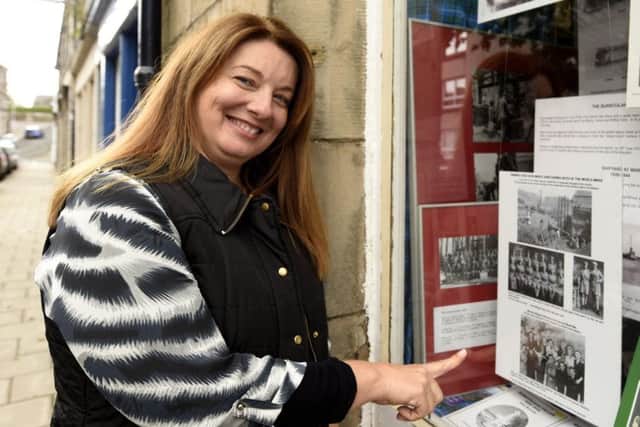 Louise Hepburn outside Burntisland Heritage Centre and the window display where she spotted her grandmother. Pic: Fife Photo Agency.