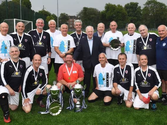 Raith Rovers Over 50s (in blue) and Fife Wanderers Over 65s, pictured with ex-Scotland manager Craig Brown, having both won their respective Scottish Cups at the largest ever Walking Football Festival held in Glasgow. Pic: SNS Group Gary Hutchison