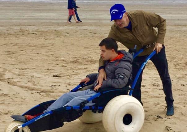 Wheelchair user Niall Mulligan enjoying West Sands with his dad.