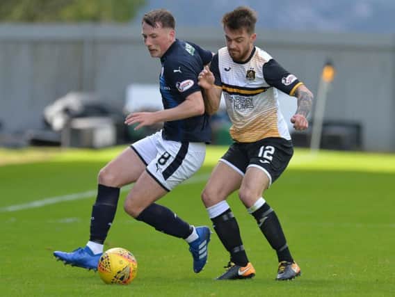 Raith midfielder Regan Hendry challenges with his current team mate, Brad Spencer, during a match at Dumbarton last season.