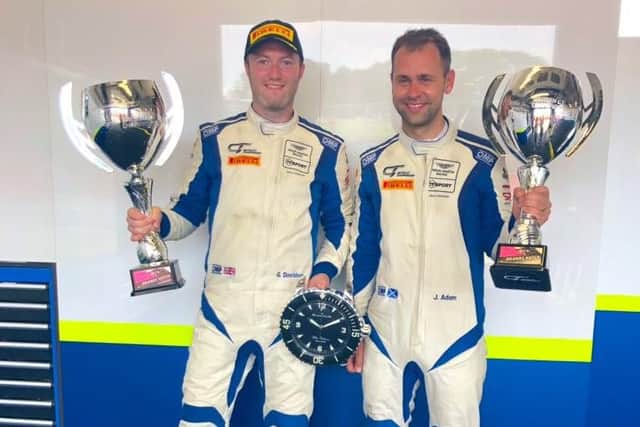 Jonny Adam (right) collects his trophy alongside TF Sport co-driver Graham Davidson.