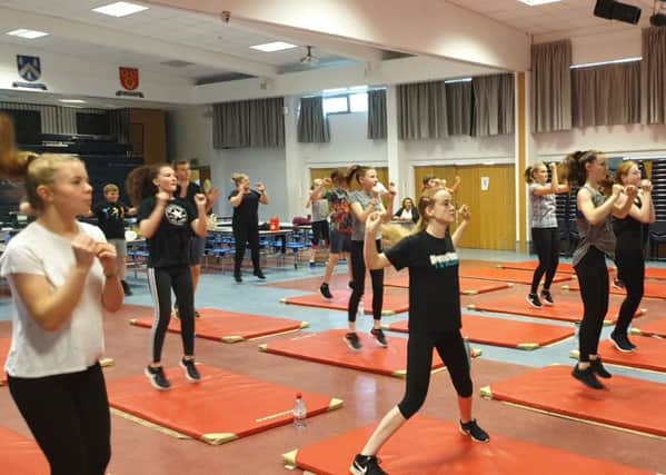 The pupils and parents taking part in the insanity workout sessions.