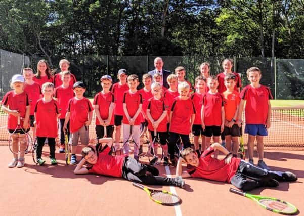 Kirkcaldy Lawn Tennis Club teams are pictured with Neil Dibble of sponsors Specsavers Kirkcaldy