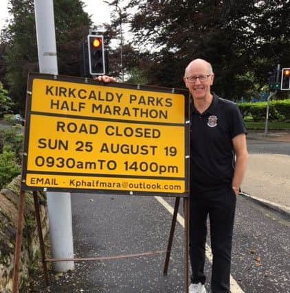 Councillor Alistair Cameron, who has been part of the team getting the event up and running, with one of the road closure signs which can be seen at various areas across the town.