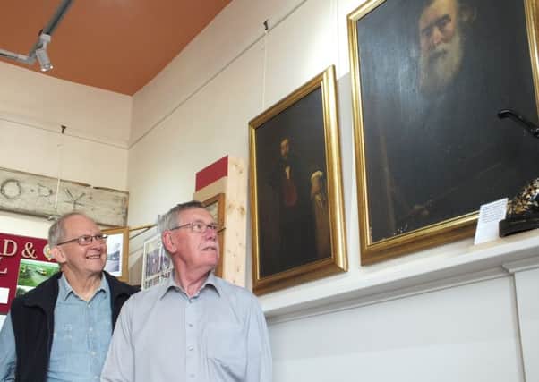 Guthrie and Ian with the two portraits.
