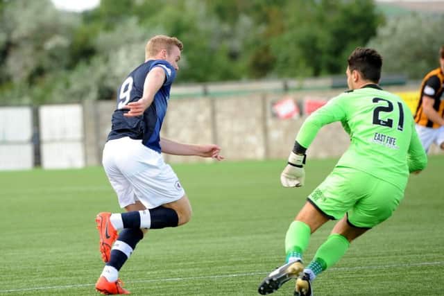 Lewis Allan takes the ball past goalkeeper Jordan Hart to open the scoring.