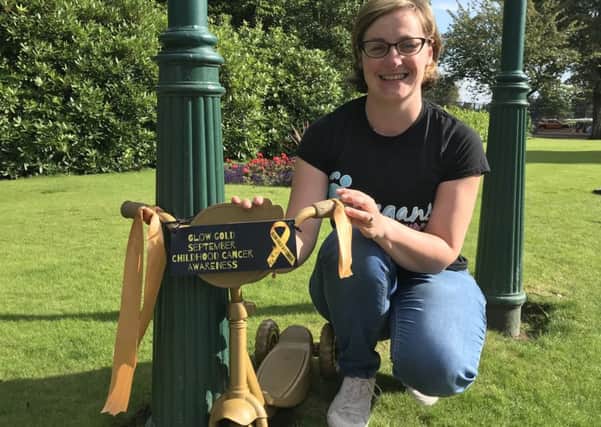 Kirkcaldy mum Kelly Clarkson with one of the spray-painted bikes for the Glow Gold September Campaign which raises awareness of childhood cancer.
