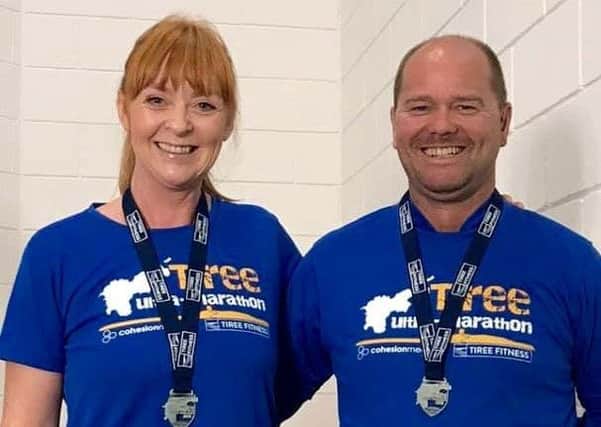 Davie Hogg and Karen Richards with their Tiree 35 Mile Ultra medals.