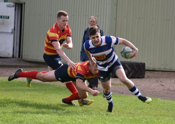 Howe winger Euan Muir evades two defenders to score Howe's first try. Pic by Chris Reekie.