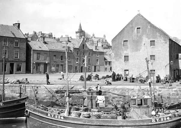 Fishing boats and fishermen in  Pittenweem Harbour