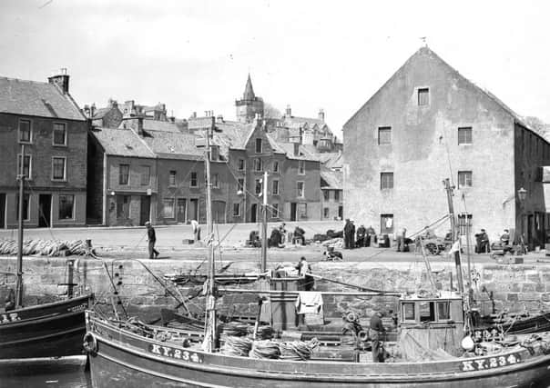 Fishing boats and fishermen in Pittenweem Harbour.