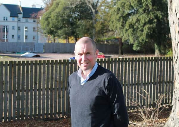 St Andrews councillor Brian Thomson at the Abbey Park Avenue  site which he believes would be better used for social housing.