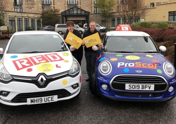 Lynne and Euan pictured with their cars.