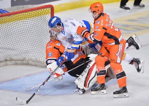 Paul Crowder collides with Sheffield Steelers netminder Tomas Duba. Pic: Dean Woolley