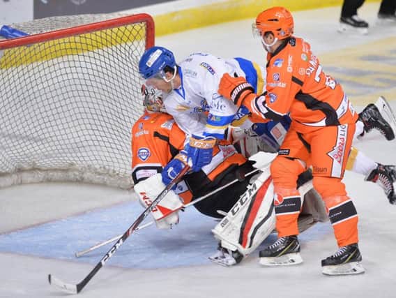 Paul Crowder collides with Sheffield Steelers netminder Tomas Duba. Pic: Dean Woolley