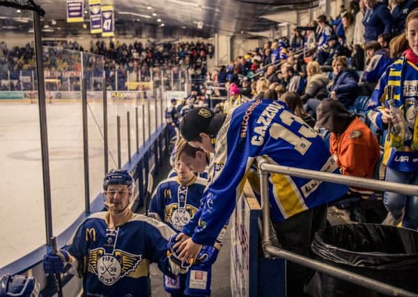 A young Fife Flyers fan offers the players a hand as they come off the ice ... and the team is calling for more positivity in the stands. Pic: Jill McFarlane