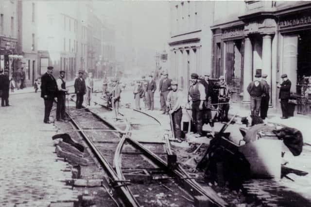 Workers laying tram lines on Kirkcaldy High Street in 1902. The trams began running the following year.