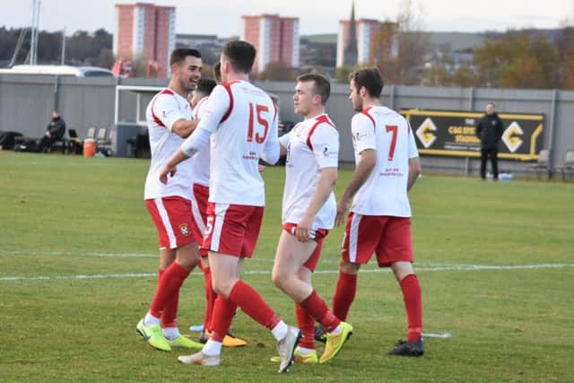 Liam Watt is congratulated after scoring his first goal.