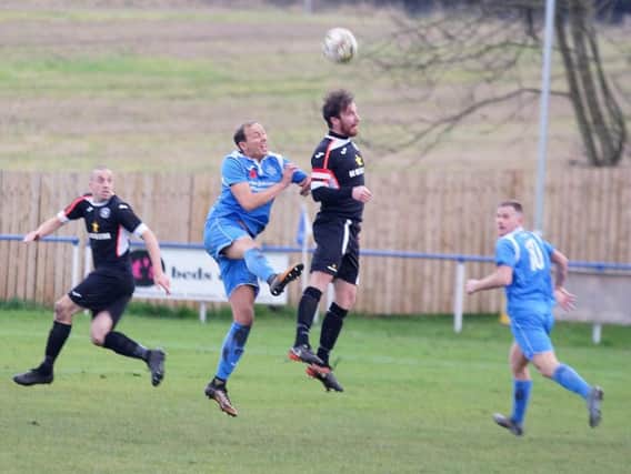 Dundonald's four goal striker Calum Smith (front left) challenges for a high ball. Pic: George Wallace